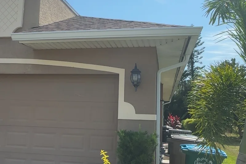 New white seamless gutter and downspout installed by Quality Over Quantity Gutters