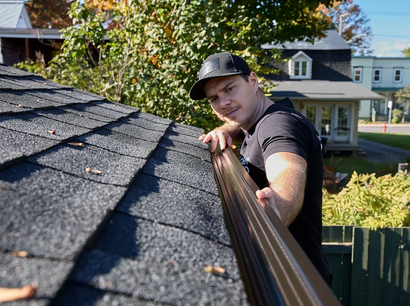 Crew carrying soffit and fascia materials along a home